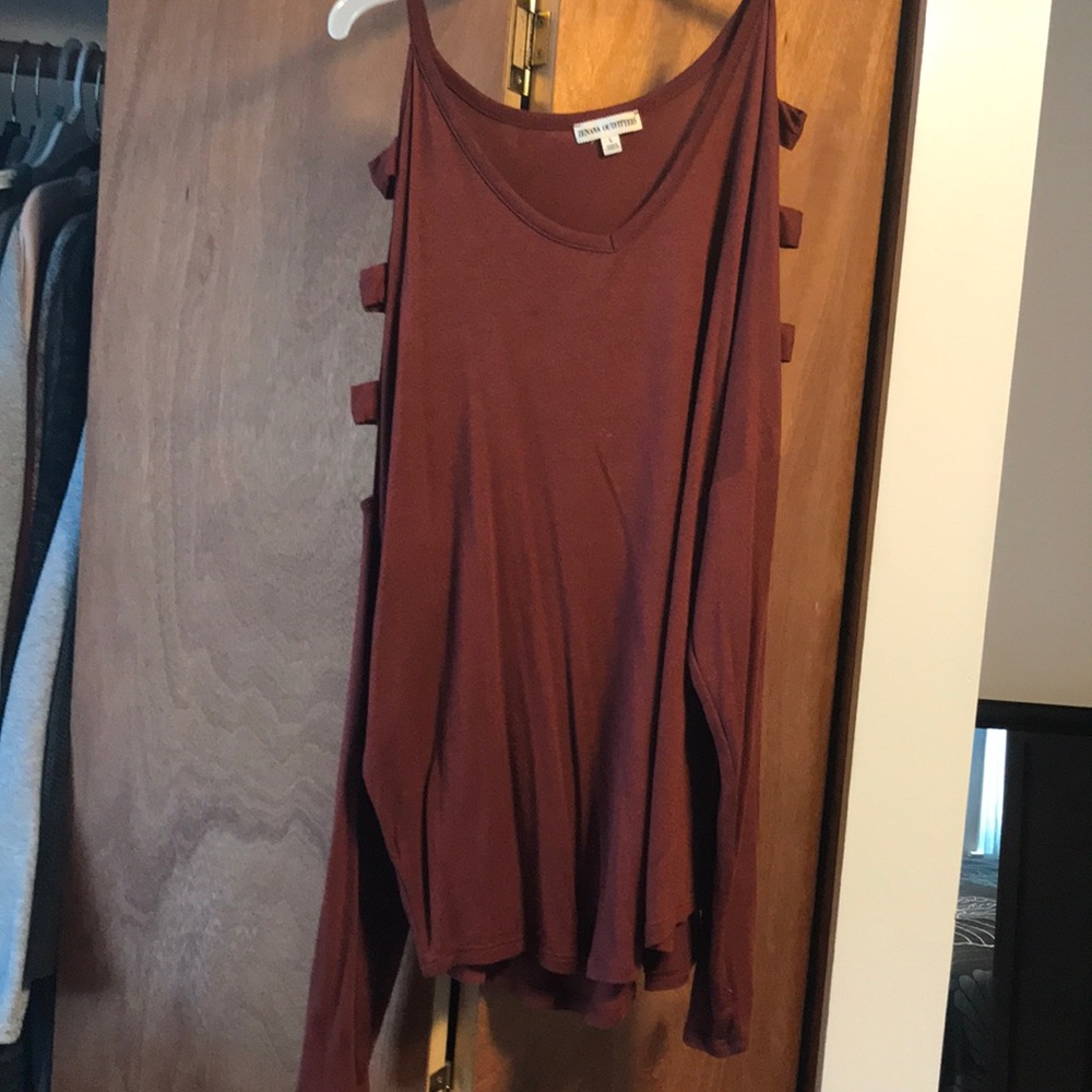 A dark orange blouse, the brand Zenana Outfitters